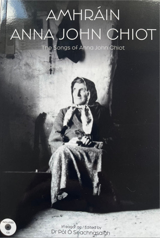 Black and white photo of a woman sitting in a cottage. The title is Amhrain Anna John Chiot, The Songs of Anna John Chiot
