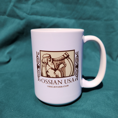 White mug with Ossian USA logo on a teal fabric background