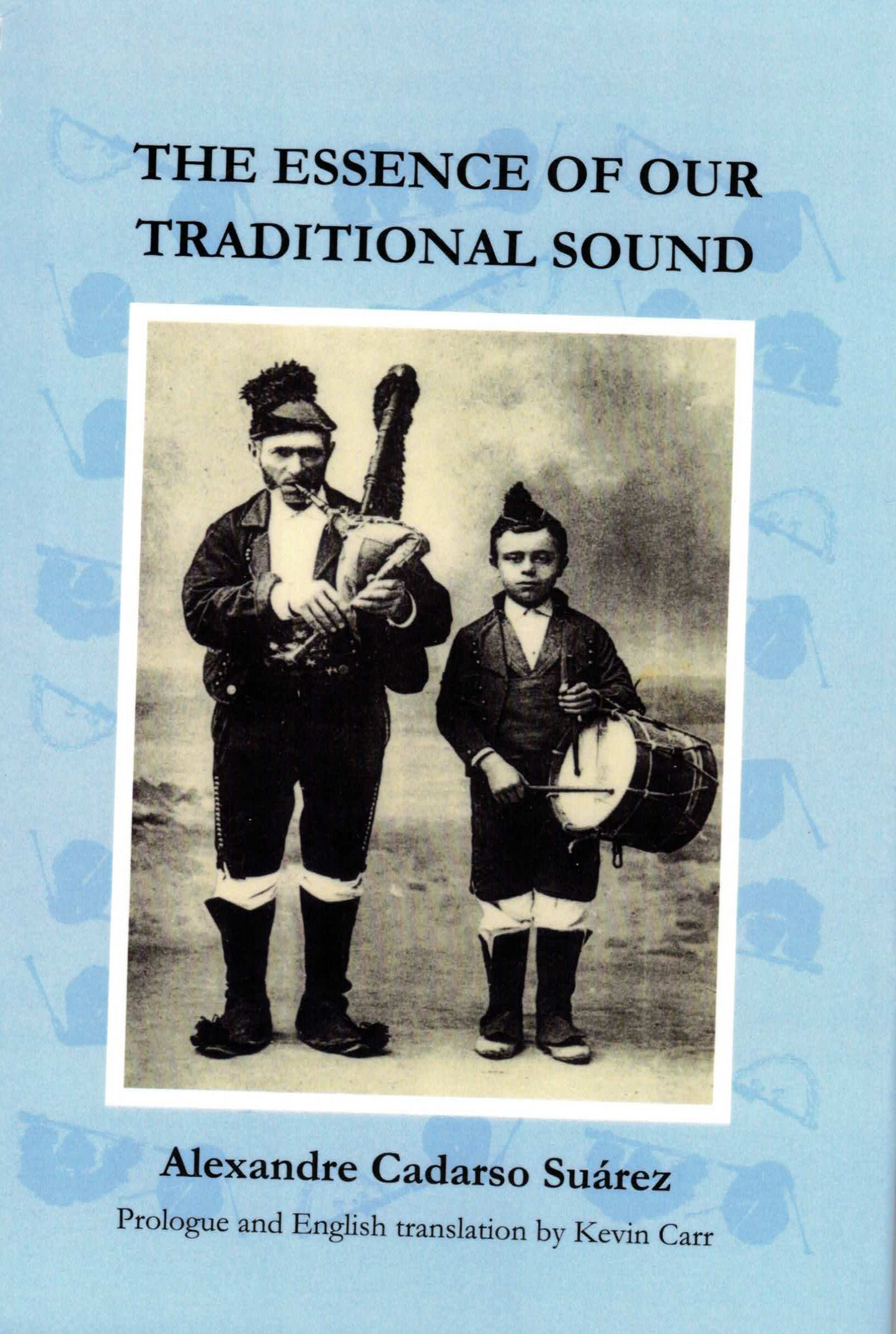 A spiral-bound book titled 'THE ESSENCE OF OUR TRADITIONAL SOUND' by Alexandre Cadarso Suárez, with a light blue cover and a vintage black-and-white photo of two men playing traditional instruments, photographed on a dark brown surface.